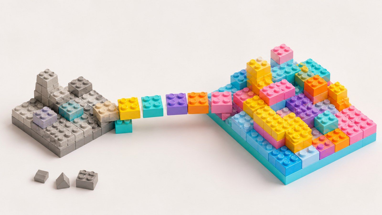 Colorful toy building blocks being moved from an old gray platform onto a new, brightly colored platform